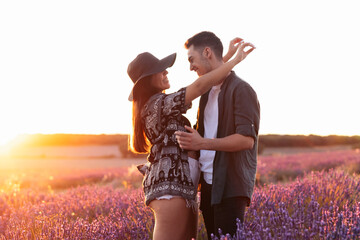 A romantic photograph of a couple in a lavender field