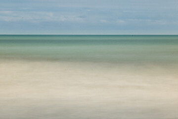 Long exposure beach. Sea foam