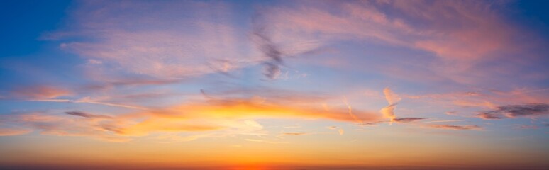 Sunset sky panorama with magenta and orange clouds 