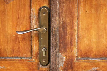 Handle with lock on wooden door