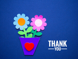 Paper flower in a pot and a red heart shape with a thank you message on a blue background. Ideas...