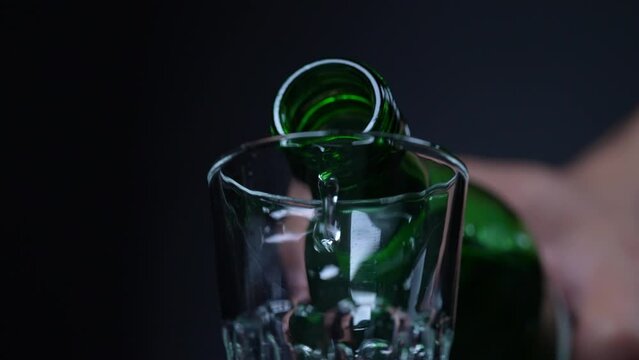 Slow motion pouring Korean traditional drink soju