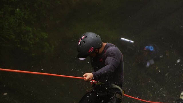 amateur rappelling down a waterfall, Slow Motion