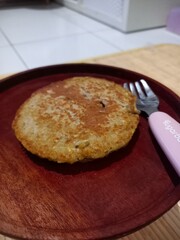 Delicious simple pancakes on wood plate. Russian and Ukrainian cuisine. The concept of the Maslenitsa holiday.