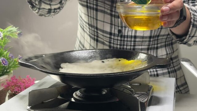 Women making or cooking Appam Palappam Kallappam vella appam made of rice batter plain hoppers