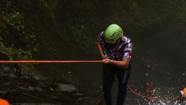 amateur rappelling down a waterfall, Slow Motion