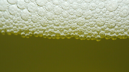 In this captivating macro close-up, foamy urine shimmers with delicate bubbles, resembling a...