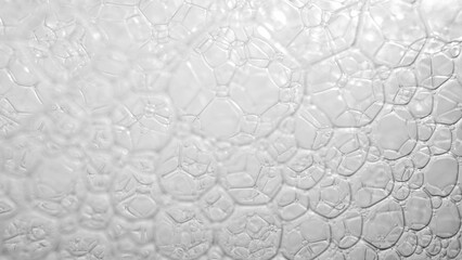 Enchanting Elegance: Mesmerizing macro close-up reveals delicate white bubbles, dancing with grace, like tiny pearls on water's surface. 
