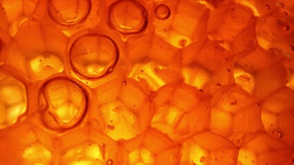Explore the mesmerizing world of honeycomb through macro, revealing hexagonal wax cells, filled with golden nectar and sealed with precision. Food concept. 
