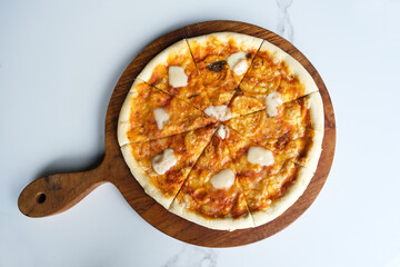 Italian Pizza Margherita with cheese and tomato sauce on serving tray
