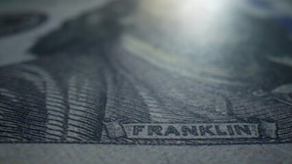 A macro zooms in on a crisp 100 dollars bill, showcasing its fine lines and intricate design. Pure...