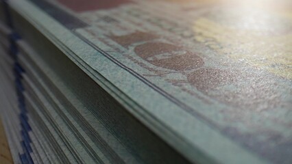 A close-up of numerous US one hundred-dollar notes, showcasing their intricate design. Budget and...