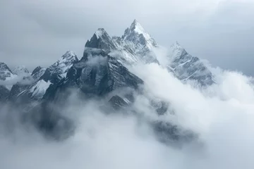 A majestic mountain range cloaked in mist, with snow-capped peaks piercing through the clouds, creating a breathtaking panorama that evokes a sense of awe. © Shaheen