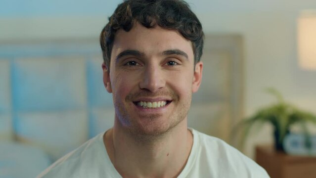 Close up happy Caucasian young man looking at camera toothy dental smile joy fun home bedroom male guy enjoy face expression facial emotion portrait smiling laugh positive relaxation cheerful gesture