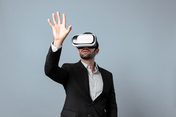 Professional smart business man holding something while wearing VR glasses. Caucasian project...