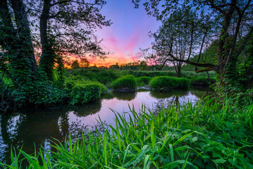 Spring sunset over the wild river banks