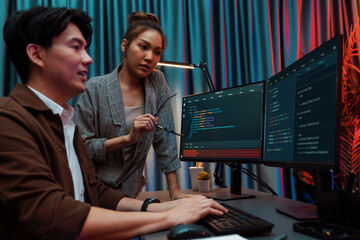 IT developers discussing with point to intelligent website development coder system running data...