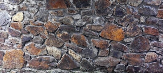 Stone wall and grape on old tiled roof in Georgia
