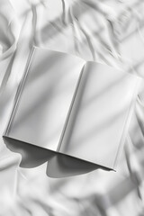 An open book with grey handwriting rests on a white clothcovered bed