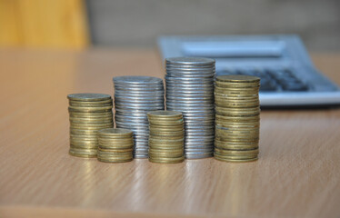 stack of coins on the table close-up. blurred background