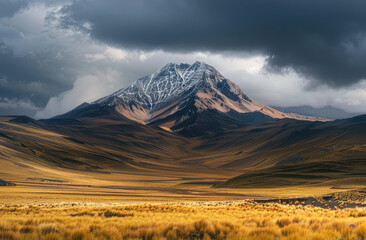 A majestic mountain peak in the Andes range, with its sharp outline and rugged terrain, stands tall against a backdrop of dark storm clouds