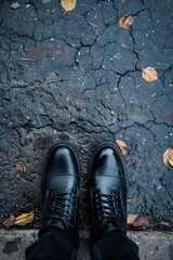 Black shoes on city pavement