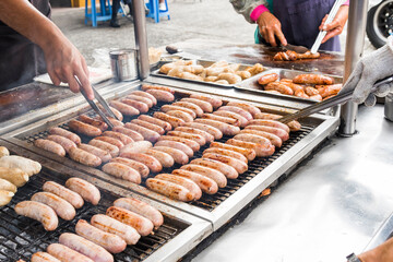 Close-up of the vendors grilling Taiwanese sausage and sticky rice (glutinous rice) sausage in the...