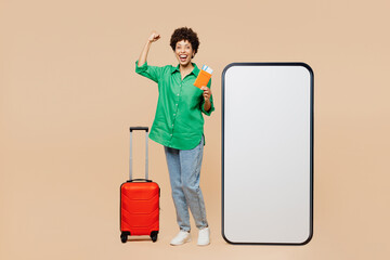 Full body traveler woman wear green casual clothes big huge blank screen mobile cell phone hold...