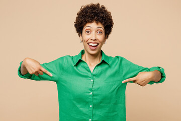 Young excited jubilant woman of African American ethnicity she wear green shirt casual clothes...