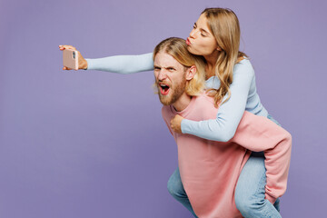 Young couple two friends family man woman wear pink blue casual clothes together giving piggyback...
