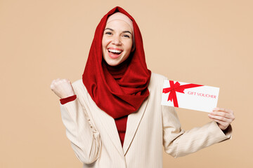 Young Arabian Asian Muslim woman wear red abaya hijab suit clothes hold store gift coupon voucher...