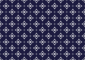 Obraz premium White symbol flowers on dark blue background, ethnic fabric seamless pattern design for cloth, carpet, batik, wallpaper, wrapping etc.