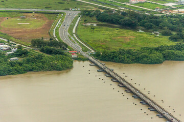 The world's longest movable vehicular pontoon bridge over the Demerara River in Georgetown, Guyana, South America. Aerial view. World tourism, attractions, landscape.