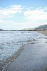 Obraz premium Mediterranean seaside coast in stormy weather on mountain background in one evening.