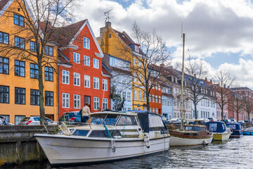 View of water front in Christianshavn district of Copenhagen with boats and yachts moored along a...