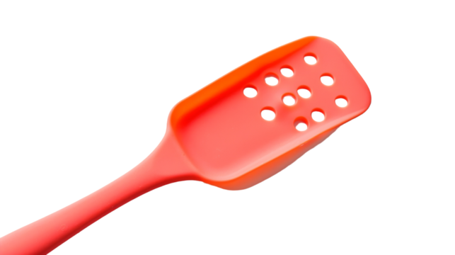A red spatula resting on a plain white surface - Powered by Adobe