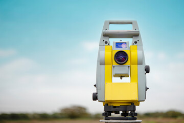 surveyor optical equipment  tacheometer or theodolite on construction site against blue sky with copy space 