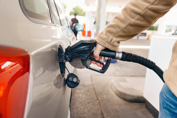 man filling fuel tank of car with diesel at petrol station     © Iryna