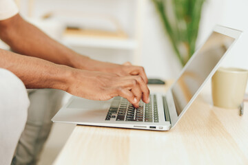 Smiling African American Freelancer Working on Laptop in Modern Home Office