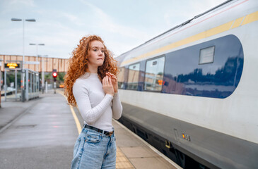 troublous traveler woman waiting for train at railway station Travel concept	