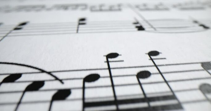 Musical notes printed on sheet of paper closeup