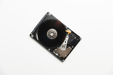 Hard drive from a PC disassembled on a white background. Data recovery concept