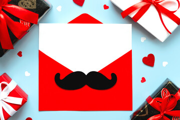 Happy Father's Day. Top view of red envelope with mustache and letter with copy space for text,...