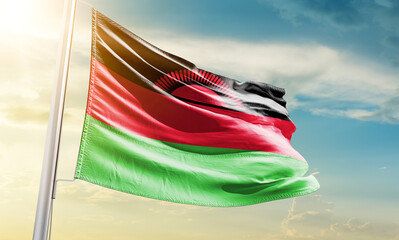 Malawi national flag waving in beautiful sky.