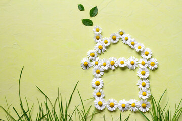 Small house made of flowers with leaves flying from chimney, eco friendly home concept