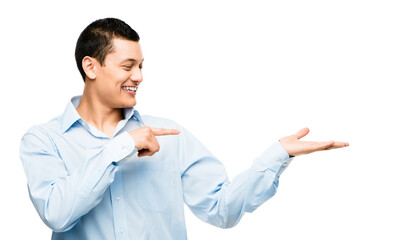 Hand space, pointing or happy businessman in studio on white background for promotion mockup or launch. Smile, contact or confident sales person showing deal offer, announcement or investment news