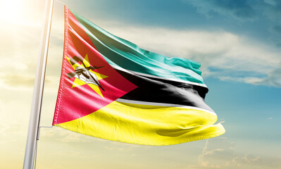 Mozambique national flag waving in beautiful sky.