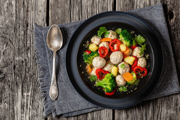 chicken meatball soup with vegetables in a bowl