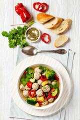 chicken meatball soup with vegetables in a bowl