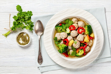 chicken meatball soup with vegetables in a bowl